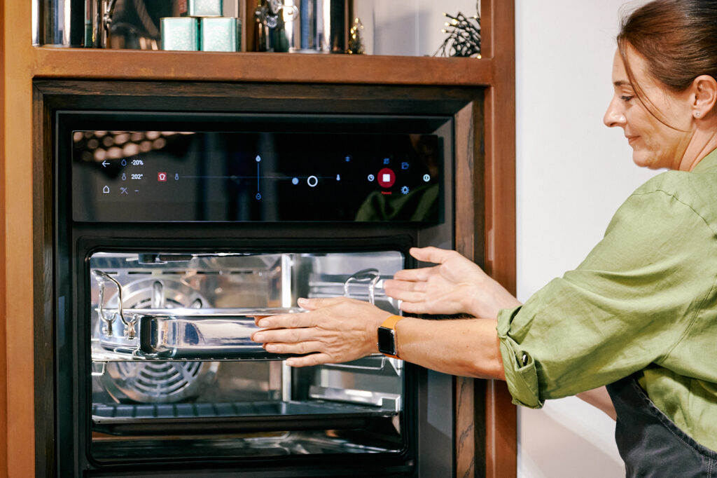 ProWare's Christmas Gift Guide - woman putting roasting pan into the oven